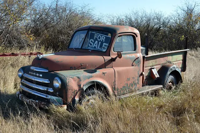 Old Dodge truck for sale in the grass